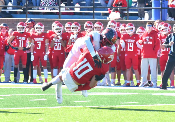 Del City's Ricklan Holmes (top) delivers a sack during the Eagles' Class 5A semifinal win against Claremore on Nov. 24, 2023.